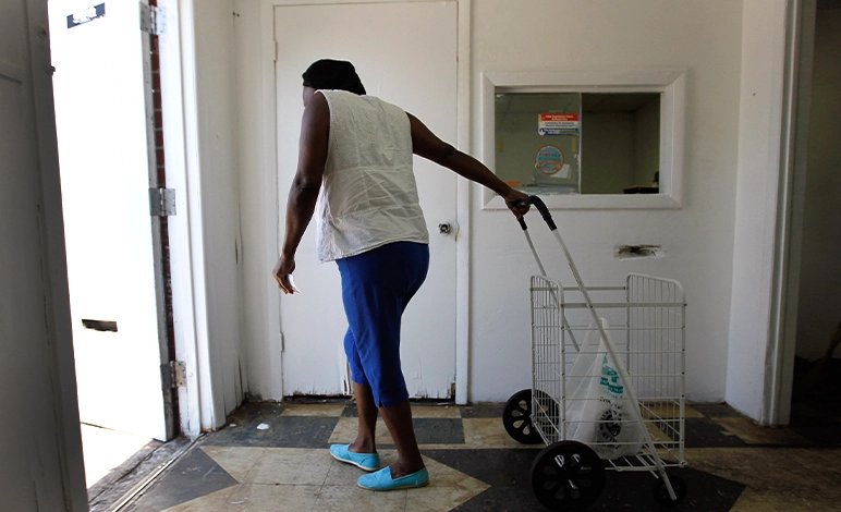 Pauline McKinney leaves&nbsp;the charity food bank in her Miami neighbourhood.