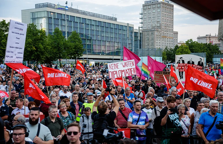 Protesters carrying banners and flags demanding action against the high food and energy prices in Leipzig, Germany