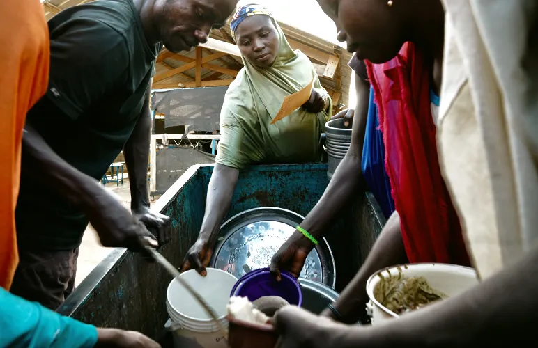A hospital worker distributes food for anaemic mothers and children at Maradi Regional Hospita