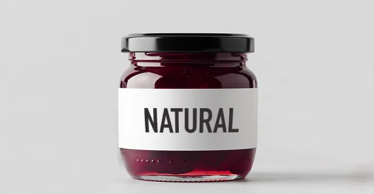 A closed jar full of a red substance with a label saying NATURAL on the front