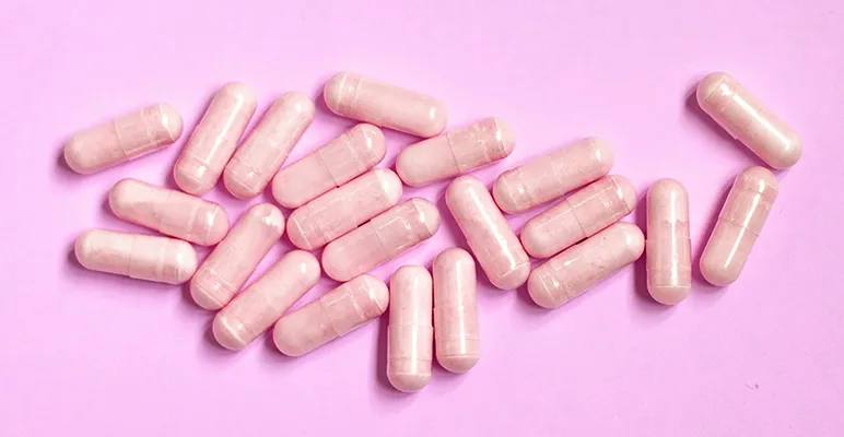 Prebiotic supplements on a pink background