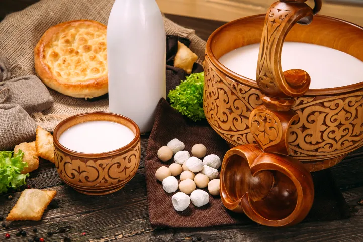 A cup and large bowl of Kumis, developed by Kazakh steppe nomadic tribes