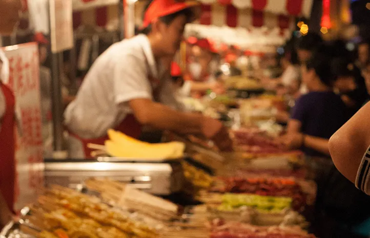 Man serving food at street food stall